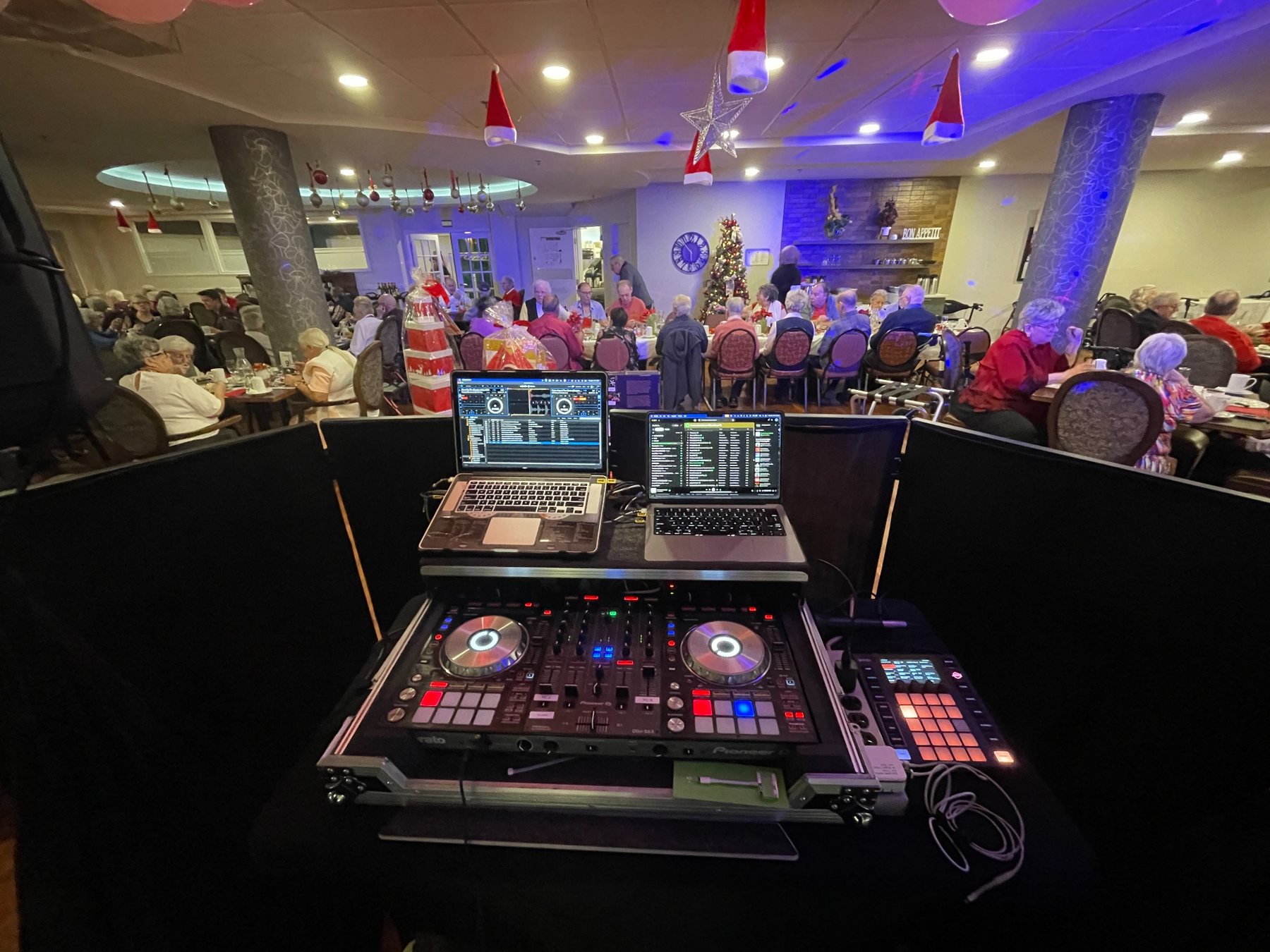 DJ setup overlooking guests on a lively dance floor