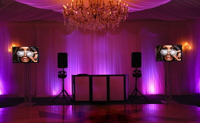 Elegant DJ booth with purple uplighting for a special event