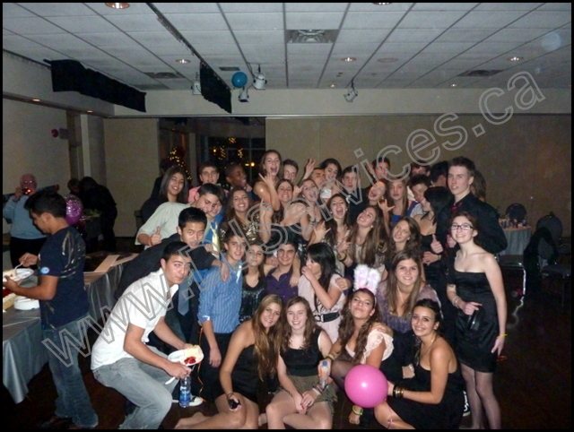 School dance crowd enjoying DJ music and event lighting