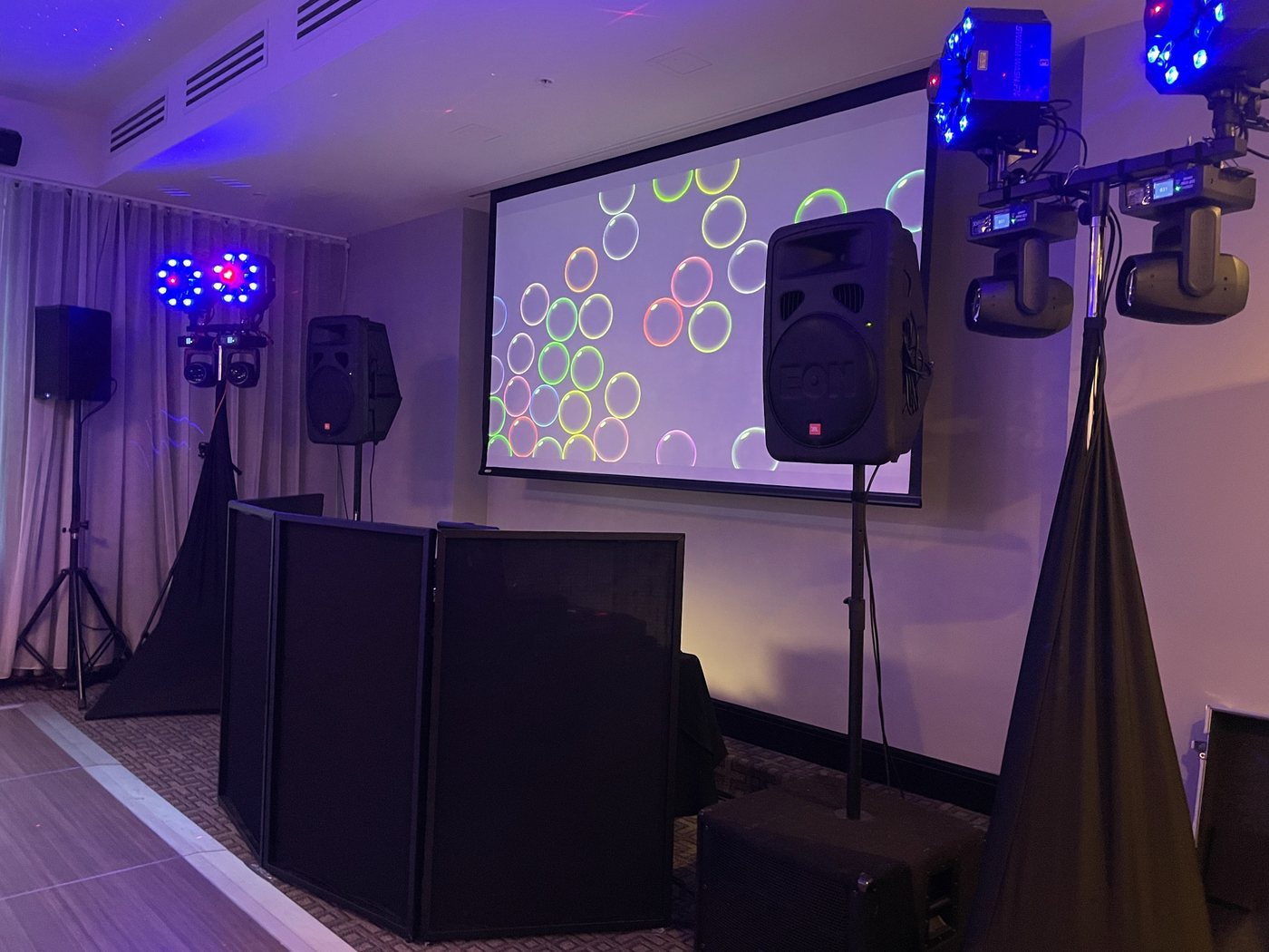Video DJ setup with large screen, professional speakers and dance-floor lighting